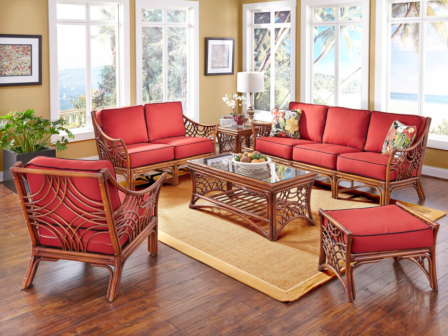 Brownwash Bali three seat sofa with red cushions in a sunroom, with the loveseat, arm chair, ottoman and coffee table