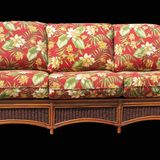 Seascape sofa in brownwash, front view with red tropical floral seat and back cushions